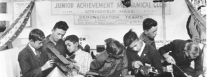 black and white photo of kids building vehicles