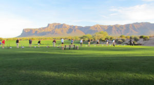 People golfing near Superstition Mountains