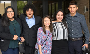 Group of teen students wearing professional clothing and smiling