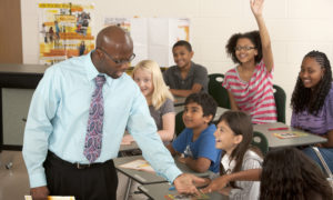 Male educator giving instructions to students