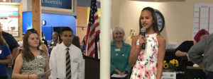 Girl speaking into microphone at JA Open House event