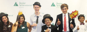 Group of kids holding photo props in front of JA backdrop