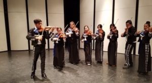 Saul playing violin in student mariachi group