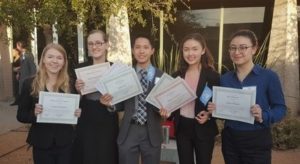 Kellen Vu standing with group of students holding certificates