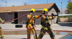 Chris Whitmeyer spraying fire hose
