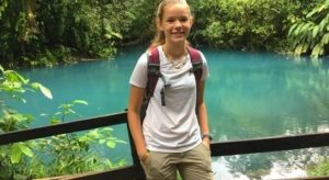 Kira Householder in the jungle in front of a blue pond