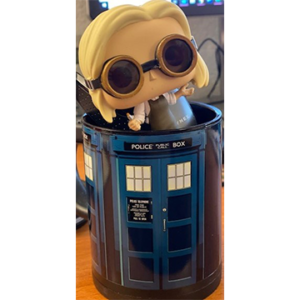 Toy figurine of blonde girl wearing goggles