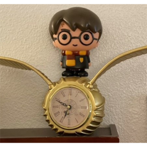 Harry Potter figurine standing on clock
