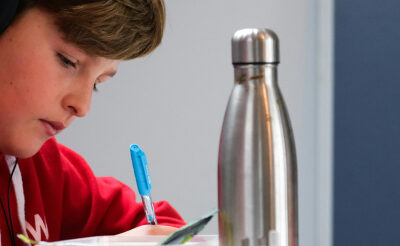 boy writing in notebook
