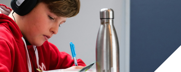 boy writing in notebook
